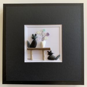 2 black cats with vase of sea glass flowers